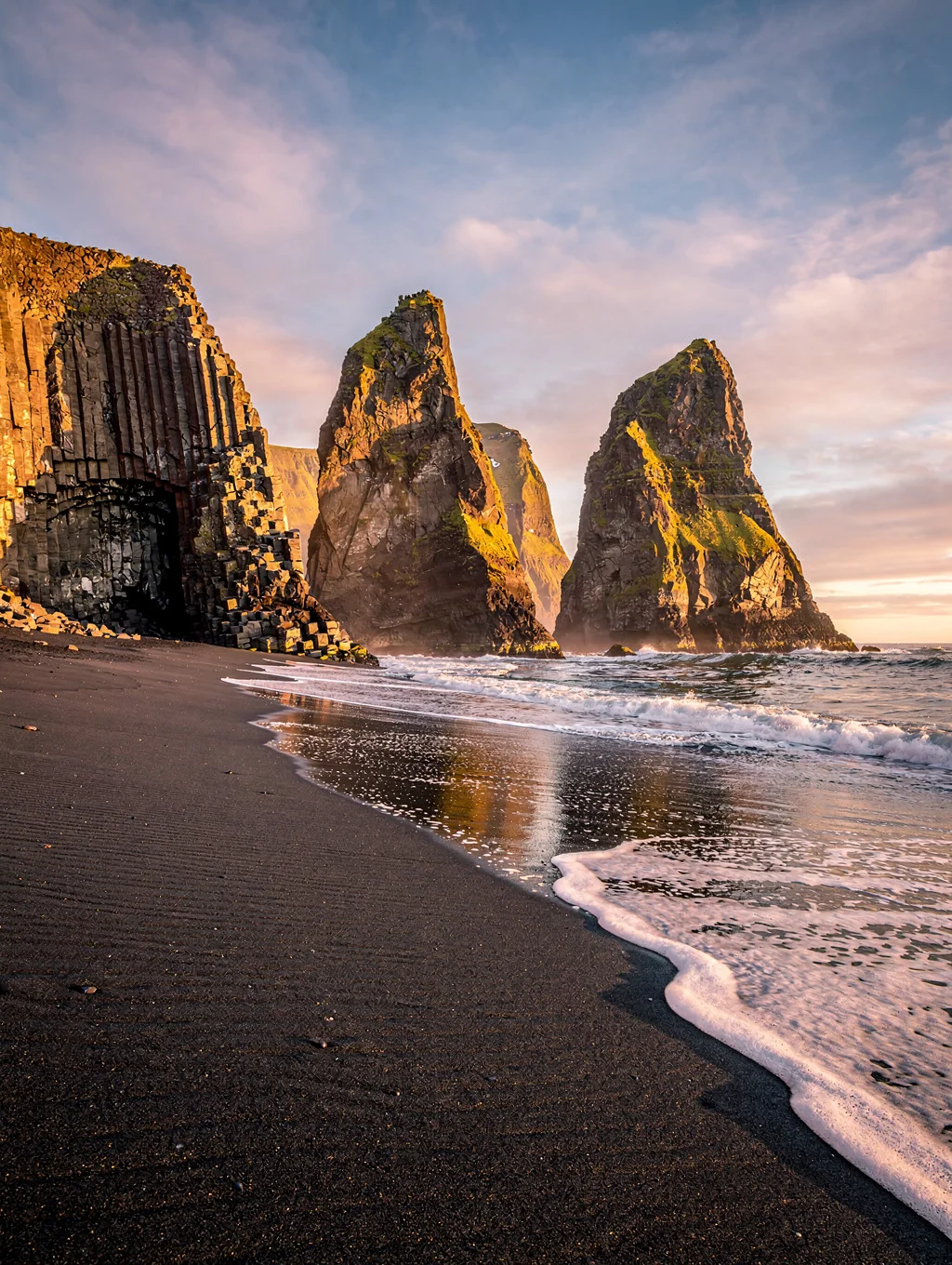 Black basalt sea stacks against crashing Atlantic waves in Iceland