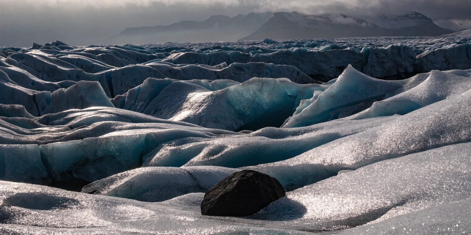 Panoramic landscape of Icelandic glacial ice and black sand